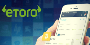 eToro aplikacja mobilna telefon zielone logo niebieskie tło